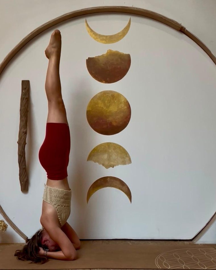 Elena Daenen in a supported headstand in her studio