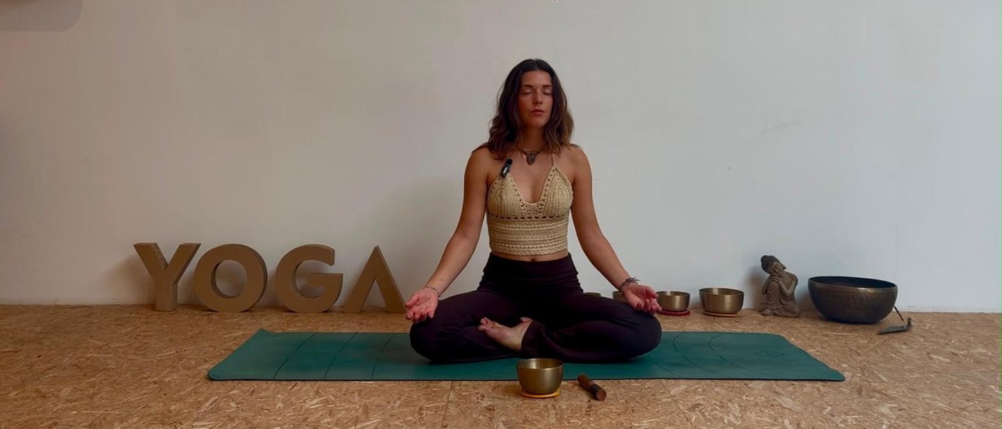 Elena Daenen meditating on her mat in the studio
